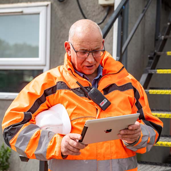 Greenworld employee holding iPad